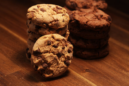 Chocolate cookies on wooden table. Chocolate chip cookies shot. Homemade food on wooden background