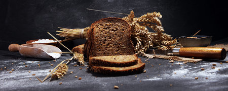 bread on black board from above. Kitchen or bakery poster design with wheat