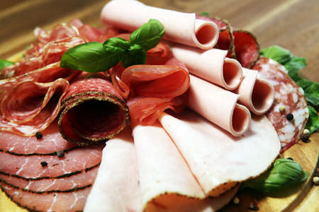 Food tray with delicious salami, pieces of sliced ham, sausage - Meat platter with selectionの写真素材