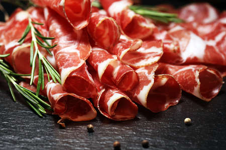 Italian sliced cured coppa with spices. Raw ham. Crudo or jamon on woodの写真素材