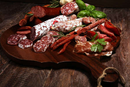 Food tray with delicious salami and herbs . Variety of meat products including coppa and sausages. cold meatの写真素材
