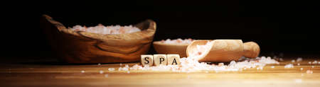 Natuaral cosmetics with pink himalayan spa salt. Sea bath salt for spa relaxation on wooden backgroundの写真素材