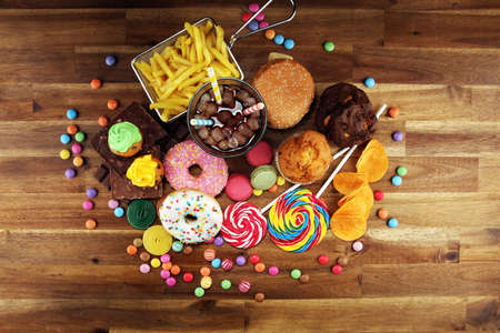Unhealthy products. food bad for figure, skin, heart and teeth. Assortment of fast carbohydrates food and softdrinkの写真素材