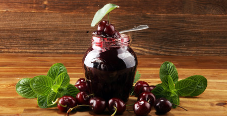 Rustic jar with cherry jam and fresh cherries, homemade preserves marmalade on woodの写真素材