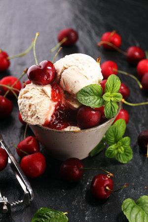 Cherry ice cream scoop with fresh cherries on a rustic background