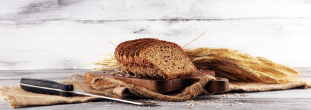 freshly baked bread on wooden board. cutted bread poster design
