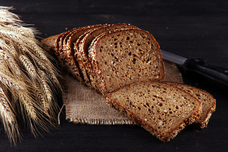 freshly baked bread on wooden board. cutted bread poster design