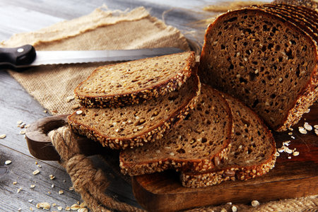 freshly baked bread on wooden board. cutted bread poster design