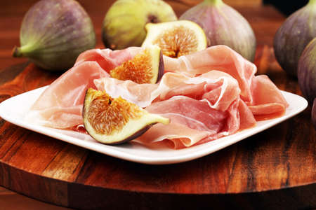 Italian prosciutto crudo or jamon with figs. Raw ham.の写真素材