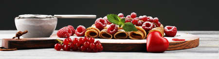 Delicious Tasty Homemade crepes or pancakes with raspberries and mint on tableの写真素材
