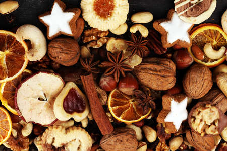 Decoration with christmas cookies. Typical cinnamon stars with fruits and nuts and dried fruitsの写真素材