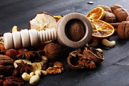 Delicious nuts and nutcrackers on an old rustic wooden table