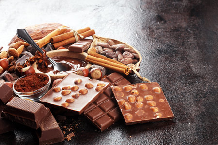 Chocolate bar pieces and melting swirl cocoa. Sweet food photo concept. The chunks of broken...