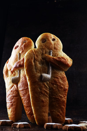 stutenkerl or weckmann. baked traditional german pastery on dark