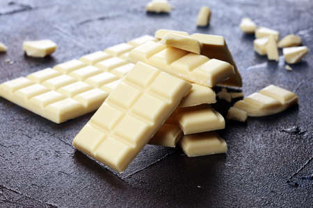 white broken chocolate and cocoa bar. Pieces of white chocolate on tableの写真素材