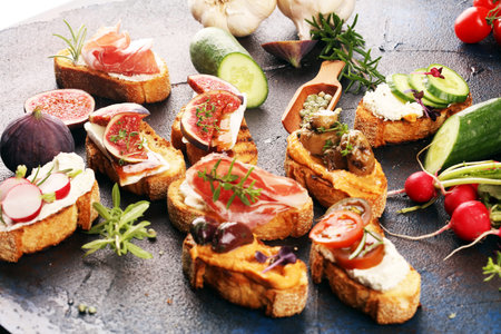 Assorted bruschetta with various toppings. Appetizing bruschetta or brie crostini. Variety of small...