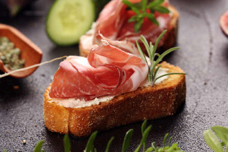 Assorted bruschetta with various toppings. Appetizing bruschetta or brie crostini. Variety of small sandwiches. Mix bruschettaの写真素材