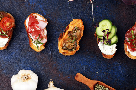 Assorted bruschetta with various toppings. Appetizing bruschetta or brie crostini. Variety of small...