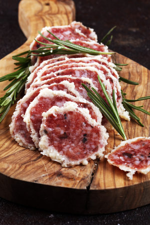 Salami truffle. The saltufo is a piece of salami mixed with summer truffle on table