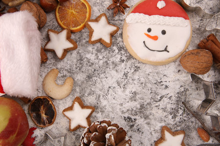 Christmas cookies and spices on rustic background with ingredients for xmas