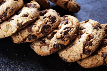 Chocolate cookies on wooden table. Chocolate chip cookies shot on black