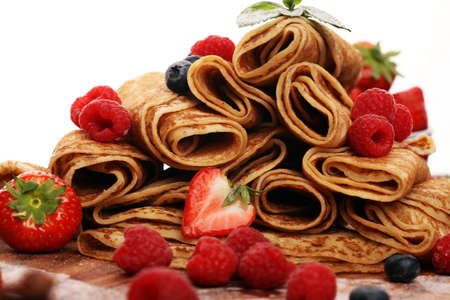 Delicious Tasty Homemade crepes or pancakes with raspberries and mint on tableの写真素材