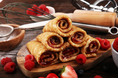 Delicious Tasty Homemade crepes or pancakes with raspberries and mint on table