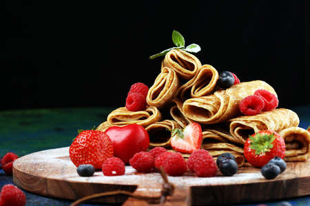 Delicious Tasty Homemade crepes or pancakes with raspberries and mint on tableの写真素材