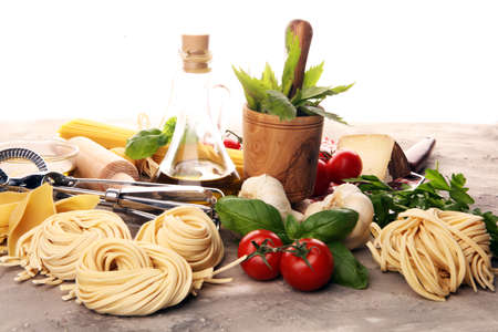 Pasta, vegetables, herbs and spices for Italian food on tableの写真素材