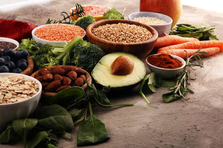 Healthy food clean eating selection: fish, fruit, vegetable, cereal, leaf vegetable on backgroundの写真素材