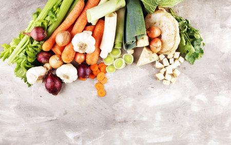 Vegetables cooking ingredients for tasty vegetarian dishes or soup. Carrot , onion , garlic ,...