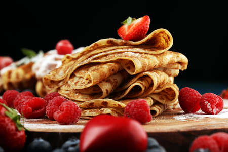 Delicious Tasty Homemade crepes or pancakes with raspberries and mint on tableの写真素材