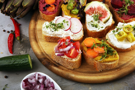 Assorted bruschetta with various toppings. Appetizing bruschetta or brie crostini. Variety of small...
