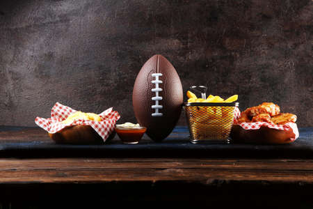 chicken wings, fries and onion rings for football on a table. Great for Bowl football Gameの写真素材