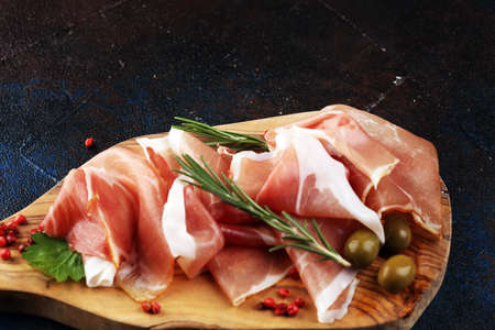 Italian prosciutto crudo or jamon with rosemary. Raw ham appetizerの写真素材