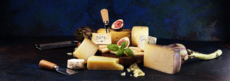 Different sorts of cheese. Cheese platter with different cheese and spices