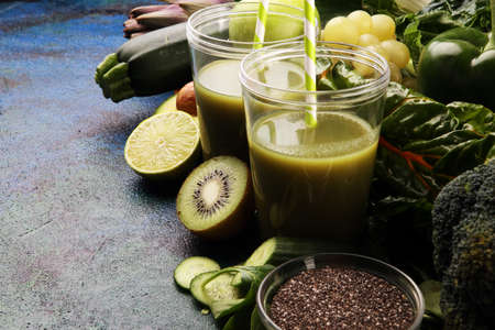 Healthy green smoothie and ingredients - detox, diet, health, vegetarian food concept with vitaminの写真素材