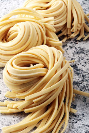 Closeup of raw fresh homemade pasta. fresh italian traditional raw pastaの写真素材