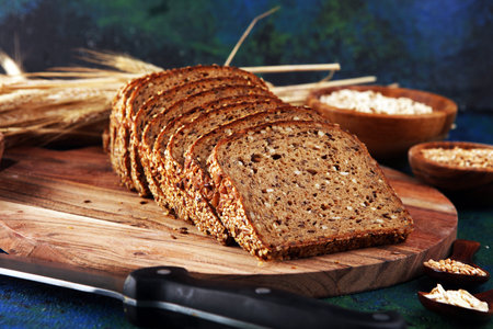Assortment of baked bread and bread rolls and cutted bread. Bakery poster concept