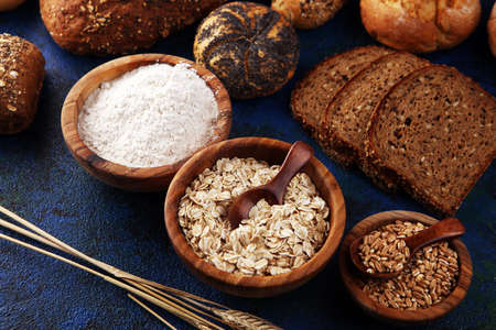 Assortment of baked bread and bread rolls and cutted bread. Bakery poster concept