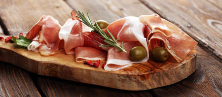 Italian prosciutto crudo or jamon with rosemary. Raw ham appetizerの写真素材