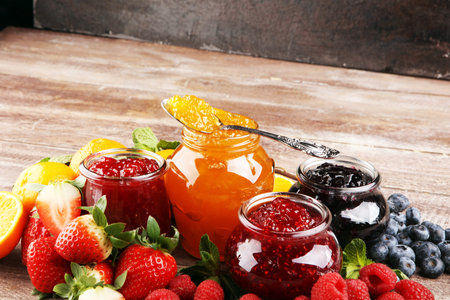 assortment of jams, seasonal berries, plums, mint and fruits, tangerine marmeladeの写真素材