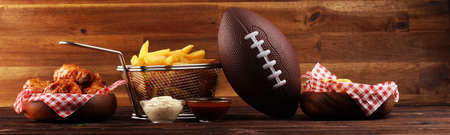 chicken wings, fries and onion rings for football on a table. Great for Bowl football Gameの写真素材