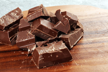 Dark chocolate stack, chips and powder with chocolate bars