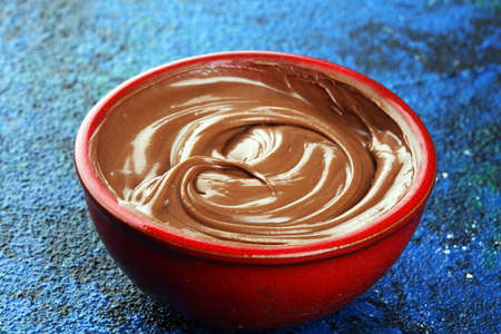 Homemade hazelnut spread in wooden bowl. Hazelnut Nougat cream on tableの写真素材