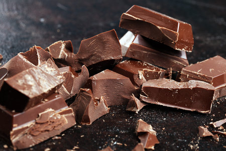 Dark chocolate stack, chips and powder with chocolate barsの写真素材