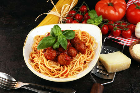 Spaghetti pasta with meatballs and tomato sauce, with parmesan and basilの写真素材