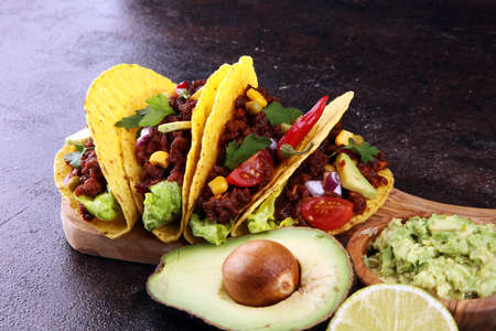 Mexican tacos with beef, tomatoes, avocado, chilli and onions の写真素材