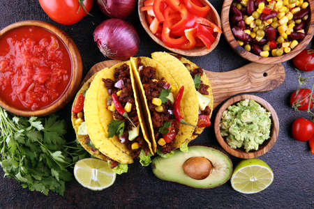 Mexican tacos with beef, tomatoes, avocado, chilli and onions の写真素材