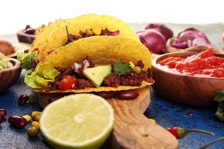 Mexican tacos with beef, tomatoes, avocado, chilli and onions の写真素材